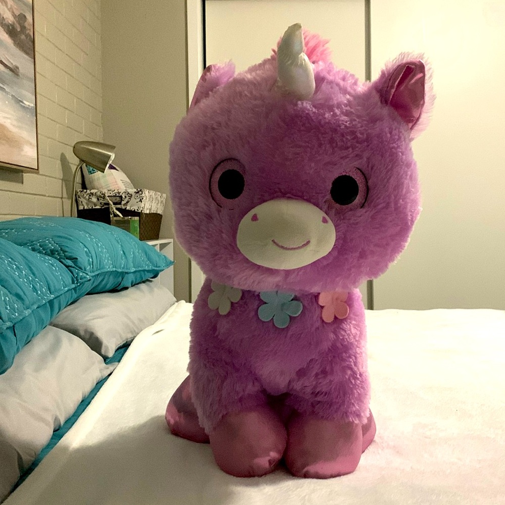 Purple unicorn with a rainbow main and tail.